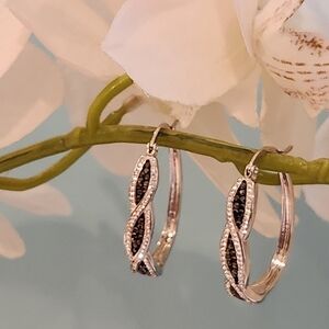 Crystal silver tone hoop earrings. Dark blue and clear stones.